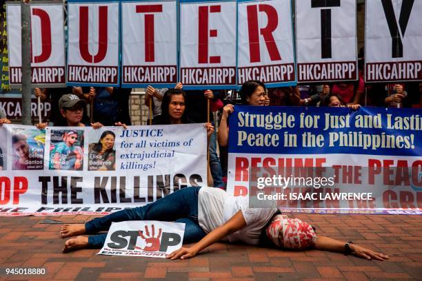 Protester lies on the ground acting out a victim of an extrajudicial killing during a protest by Filipino migrant organisations, as well as local and...