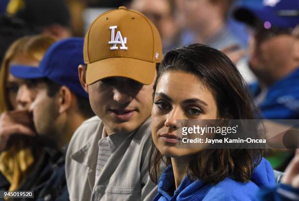 Actors Ashton Kutcher and Mila Kunis attend the game between the Los Angeles Dodgers and the Oakland Athletics at Dodger Stadium on April 11, 2018 in...