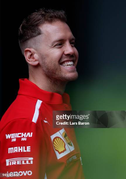Sebastian Vettel of Germany and Ferrari looks on in the Paddock during previews ahead of the Formula One Grand Prix of China at Shanghai...