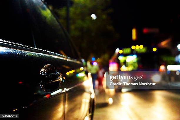car and motion blurred bus at night - austin nightlife stock pictures, royalty-free photos & images