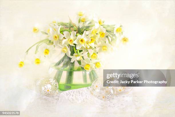 a still-life easter display with glass easter eggs and spring daffodils in a vase - narcissus mythological character 個照片及圖片檔