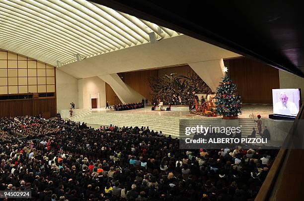 Pope Benedict XVI attends his weekly general audience while a Christmas tree and a crib are displayed in the Paul VI hall at The Vatican on December...