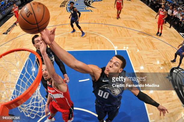 Aaron Gordon of the Orlando Magic goes for the handle against Tomas Satoransky of the Washington Wizards on April 11 2018 at Amway Center in Orlando,...
