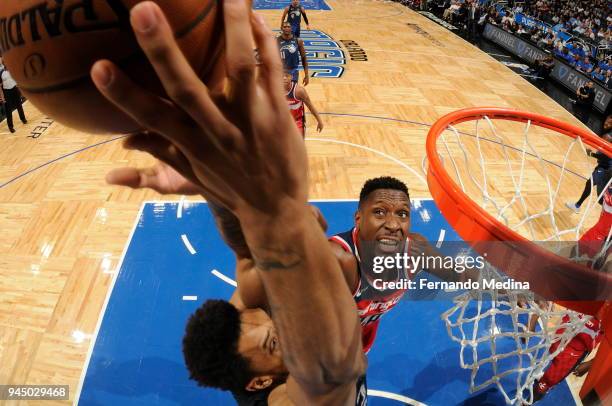 Ian Mahinmi of the Washington Wizards reaches for the ball against Khem Birch of the Orlando Magic on April 11 2018 at Amway Center in Orlando,...