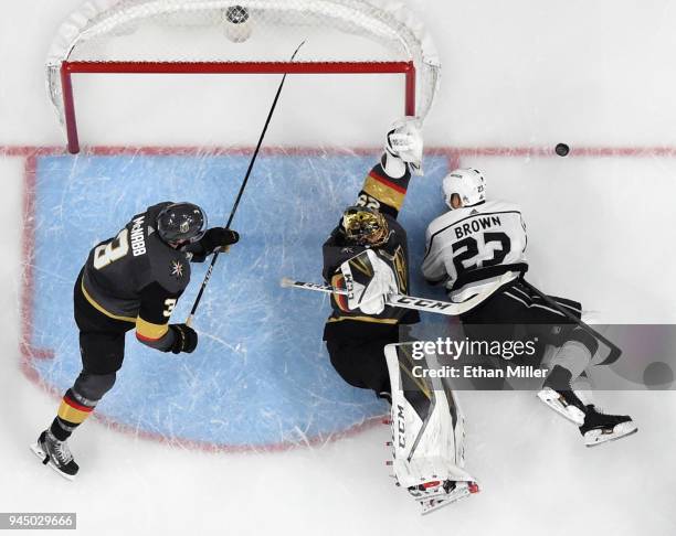 Brayden McNabb and Marc-Andre Fleury of the Vegas Golden Knights defend the net as Dustin Brown of the Los Angeles Kings falls to the ice in the...