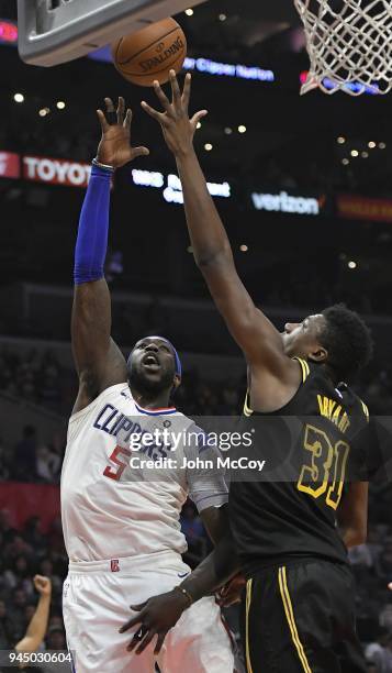 Montrezl Harrell of the LA Clippers shoots over Thomas Bryant of the Los Angeles Lakers in the second half at Staples Center on April 11, 2018 in Los...