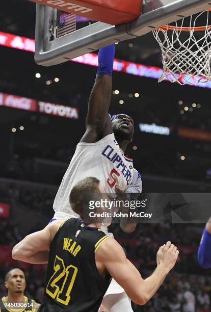 Montrezl Harrell of the LA Clippers goes up for a dunk against Travis Wear of the Los Angeles Lakers in the second half at Staples Center on April...