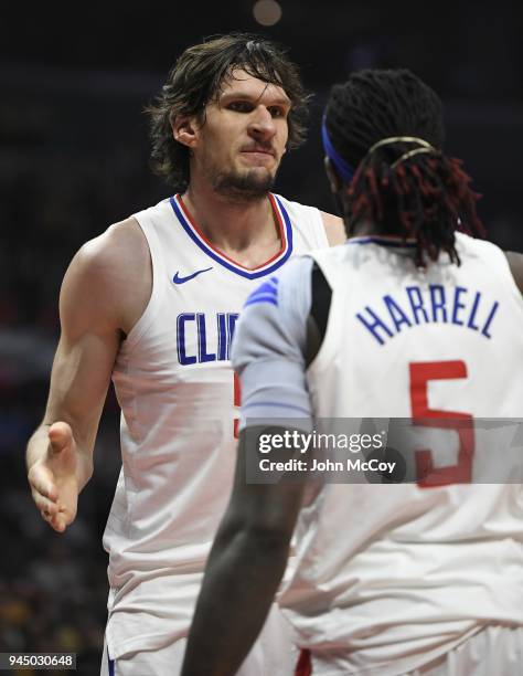Boban Marjanovic of the LA Clippers shakes hands with Montrezl Harrell of the LA Clippers in the second half at Staples Center on April 11, 2018 in...