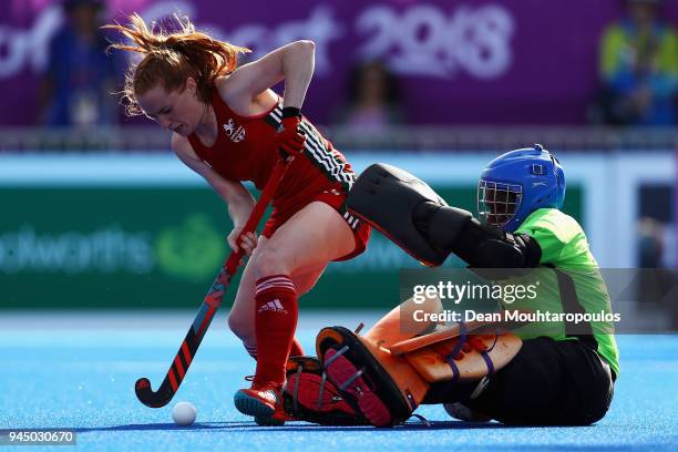 Sarah Jones of Wales battles for the ball with Bridget Azumah of Ghana during Women's Placing 9-10 hockey match between Wales and Ghana on day eight...