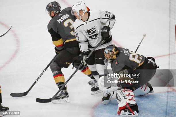 Marc-Andre Fleury and Brayden McNabb of the Vegas Golden Knights defend their goal against Dustin Brown of the Los Angeles Kings in Game One of the...