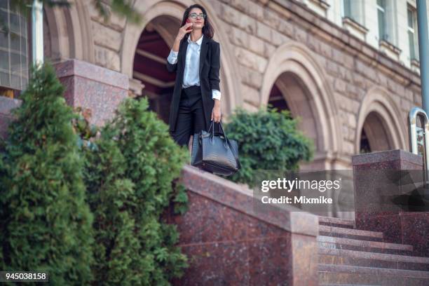 businesswoman talking on the phone - 2017 common good forum stock pictures, royalty-free photos & images