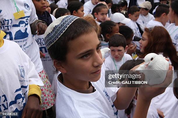 Arab and Jewish children from Jerusalem release hundreds of doves in support of captured Israeli soldier Gilad Shalit on December 16, 2009. Hamas and...