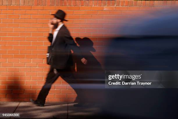 An Orthodox Jewish man walks along Hotham street in St Kilda East on April 12, 2018 in Melbourne, Australia. The Adass Israel community is...