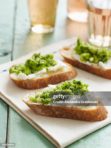 goat cheese crostini with sweet pea pesto - crostini stock pictures, royalty-free photos & images