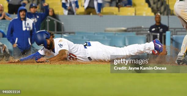 Matt Kemp of the Los Angeles Dodgers beats the throw to Jonathan Lucroy of the Oakland Athletics as he scores on a sacrifice fly by Chase Utley of...