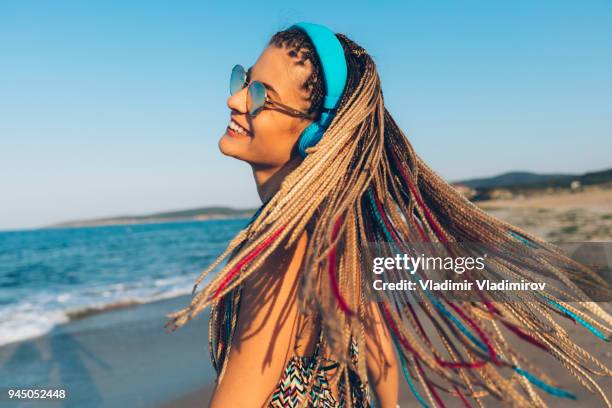 wind and multicolored braided hair - braided hair imagens e fotografias de stock