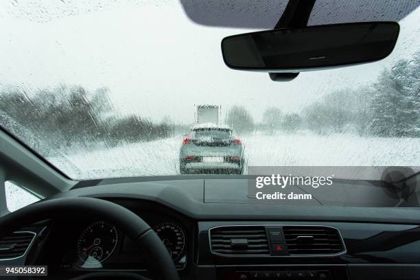 heavy traffic in winter time, view from on board of car. - car dashboard windscreen stock pictures, royalty-free photos & images