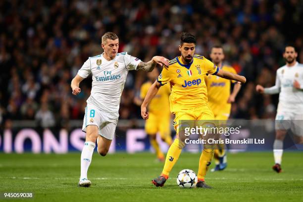 Sami Khedira of Juventus is challenged by Toni Kroos of Real Madrid during the UEFA Champions League Quarter Final, second leg match between Real...