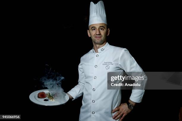 Sercan Erdogan, Executive Sous Chef at Calista Luxury Resort holds a smoking food plate as he poses for a photo in Antalya, Turkey on April 11, 2018....