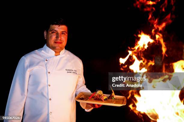Serdal Aribeyi, Executive Chef at Maritim Pine Beach Resort & Club Hotel holds a smoking food plate as he poses for a photo in Antalya, Turkey on...