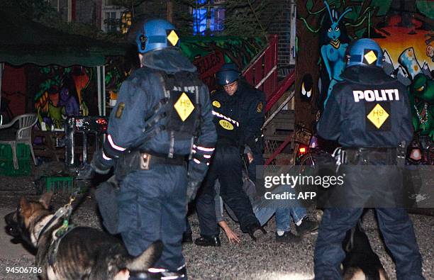 Policemen detain protesters during a demonstration late on December 14, 2009 in the Christiania squat in Copenhagen. Danish police stormed a giant...