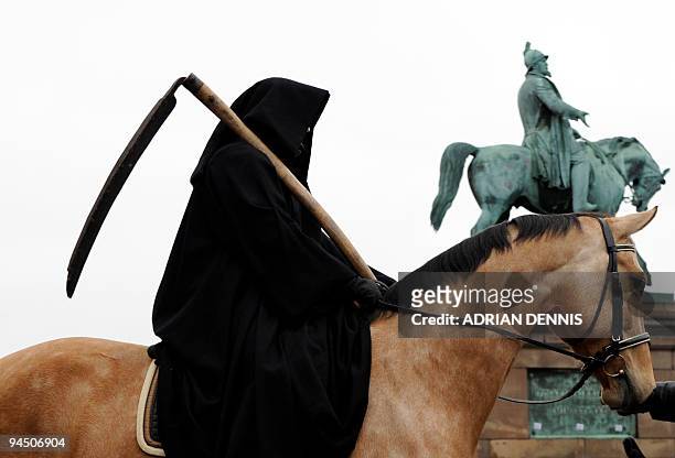 Woman dressed as "Death", of the Four Horsemen of the Apocalypse sits on a horse, during a Greenpeace demonstration in Parliament Square in...