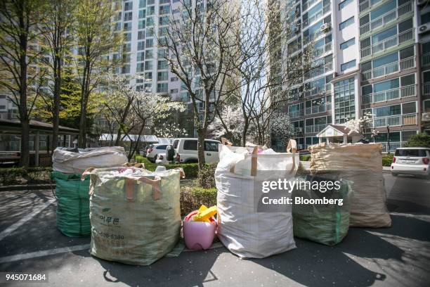 Bags of uncollected plastic waste sit outside an apartment complex in Yongin, South Korea, on Wednesday, April 11, 2018. Some South Korean recycling...