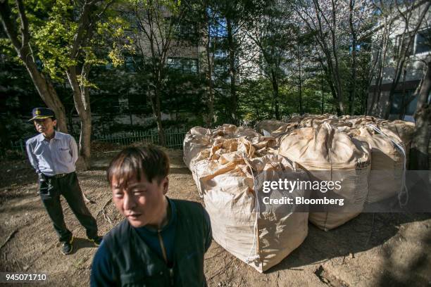 Bags of uncollected plastic waste sit at an apartment complex in Yongin, South Korea, on Wednesday, April 11, 2018. Some South Korean recycling...