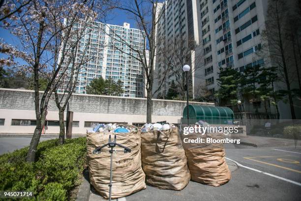 Bags of uncollected plastic waste sit at an apartment complex in Yongin, South Korea, on Wednesday, April 11, 2018. Some South Korean recycling...
