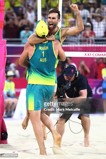 Damien Schumann and Christopher Mchugh of Australia celebrate winning match point in the Beach Volleyball Men's Gold Medal match between Damien...