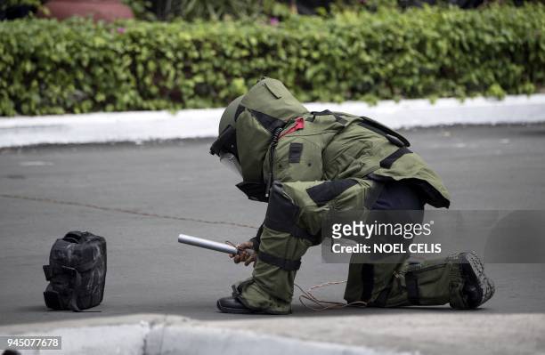 Policeman wearing an explosive ordnance disposal suit takes part in an anti-terrorism simulation exercise by police in Manila on April 12 to show...