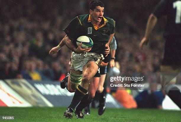 Joost van der Westhuizen of South Africa runs with the ball during the Rugby Union World Cup 1999 match against New Zealand played at the Millennium...