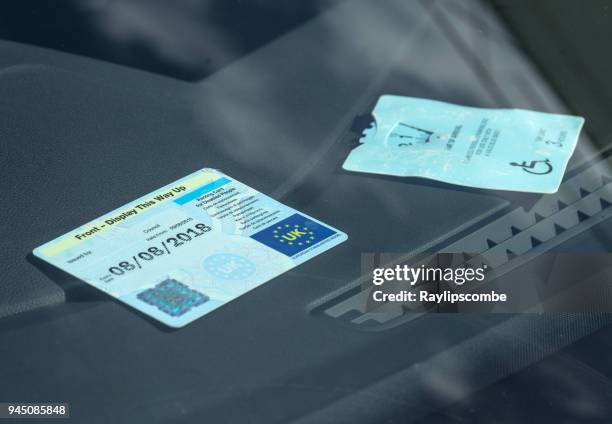 disabled car parking badge being displayed in the front of a car windscreen - disabled badge stock pictures, royalty-free photos & images