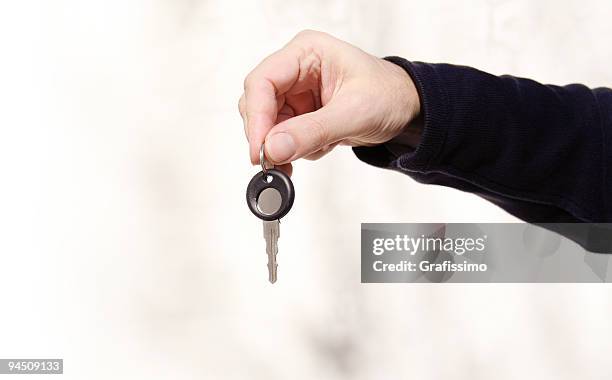 hand holding a key - turning key stock pictures, royalty-free photos & images