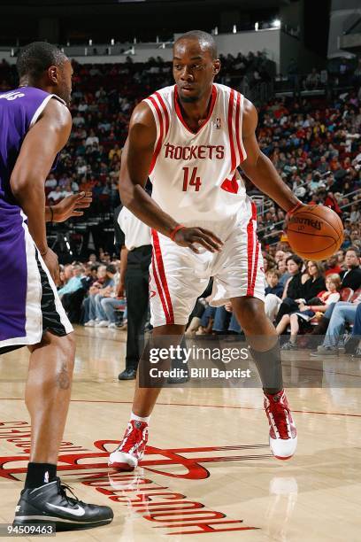 Carl Landry of the Houston Rockets drives the ball against Kenny Thomas of the Sacramento Kings during the game on November 21, 2009 at the Toyota...