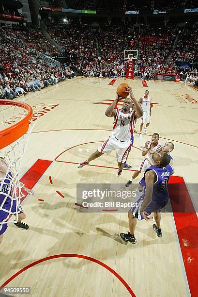 Carl Landry of the Houston Rockets shoots the ball against Kenny Thomas of the Sacramento Kings during the game on November 21, 2009 at the Toyota...