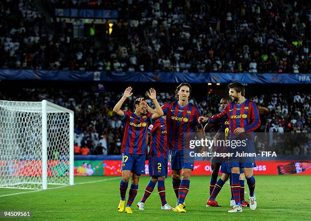 Pedro Rodriguez of FC Barcelona celebrates scoring his sides third goal with his teammates Zlatan Ibrahimovic and Gerard Pique during the FIFA Club...