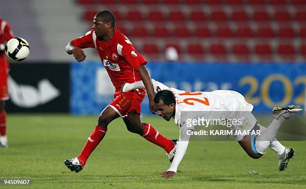 Umm Salal's Dahi al-Nubi vies with Al-Arabi club's Brazilian forward Carlos Henrique Kim during their Qatar Stars League football match in Doha on...