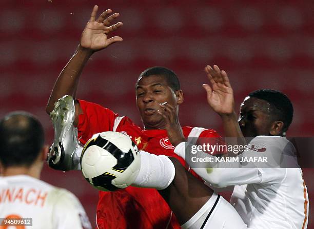 Umm Salal's Mohammed Mussa vies with Al-Arabi club's Brazilian forward Carlos Henrique Kim during their Qatar Stars League football match in Doha on...