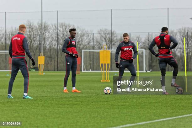 Sam Clucas, Tammy Abraham, Alfie Mawson and Kyle Bartley in action during the Swansea City Training at The Fairwood Training Ground on April 11, 2018...