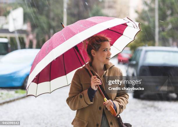 lady walking on the strong rain - umbrella rain dancing stock pictures, royalty-free photos & images