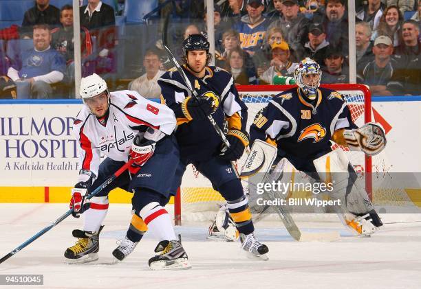 Steve Montador and Ryan Miller of the Buffalo Sabres defend against Alex Ovechkin of the Washington Capitals on December 9, 2009 at HSBC Arena in...