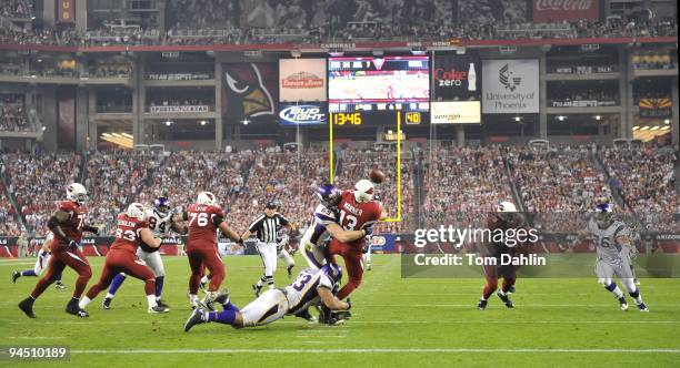 Jared Allen and Kevin Williams of the Minnesota Vikings sack Kurt Warner of the Arizona Cardinals in the NFL game against the Arizona Cardinals at...