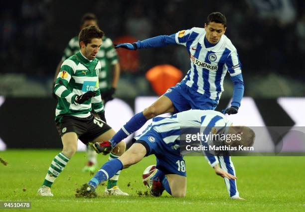 Joao Moutinho, Cicero and Artur Wichniarek battle for the ball during the UEFA Europa League match between Hertha BSC Berlin and Sporting Lissabon at...