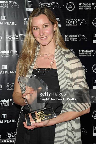 Courtney Noble of Fortissimo Films with the Muhr AsiaAfrica Feature award for Best Composer on behalf of Akritchalerm Kalayanamitr and Koichi Shimizu...