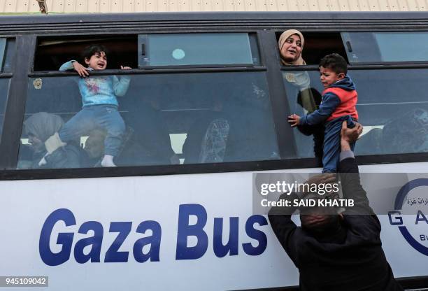 Palestinians bid farewell as they prepare to travel into Egypt after the Rafah border crossing was opened for three days for humanitarian cases, in...