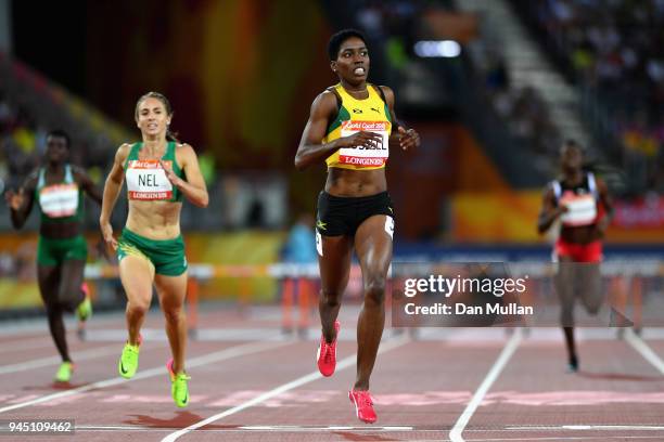 Janieve Russell of Jamaica crosses the line to win gold competes in the Women's 400 metres hurdles final during athletics on day eight of the Gold...