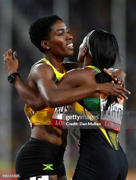 Janieve Russell of Jamaica celebrates winning gold with Ronda Whyte of Jamaica after the Women's 400 metres hurdles final during athletics on day...