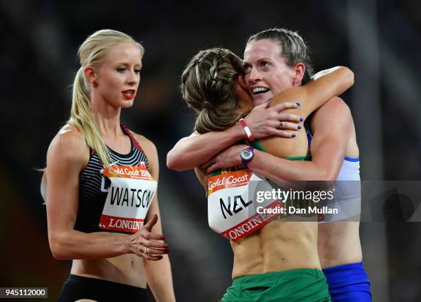 Silver medalist Eilidh Doyle of Scotland and bronze medalist Wenda Nel of South Africa embrace after the Women's 400 metres hurdles final as Sage...