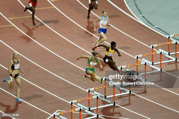 Janieve Russell of Jamaica and of Wenda Nel of South Africa compete in the Women's 400 metres hurdles final during athletics on day eight of the Gold...